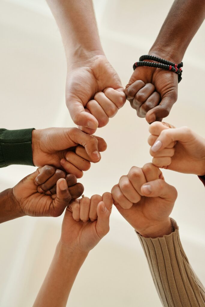 Hands of people of different races connected in a circle, to show community